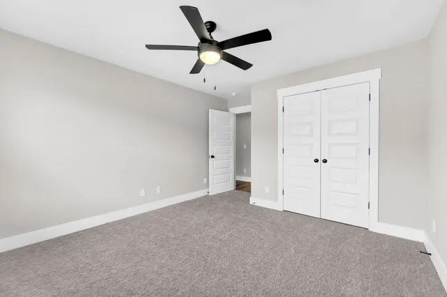 an empty room with ceiling fan