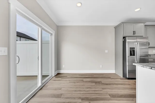 a view of a kitchen with a sink and a refrigerator