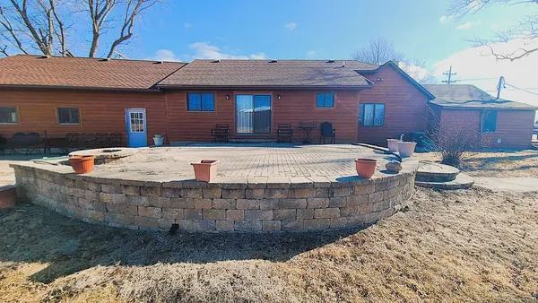 a view of a house with pool and chairs