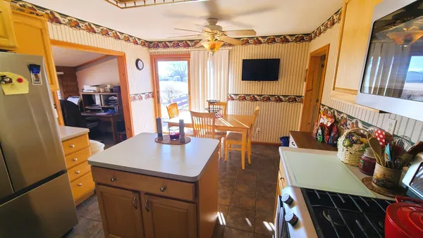 a view of a dining room with furniture and a flat screen tv