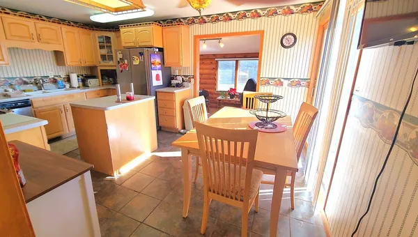 a dining room with furniture and a window