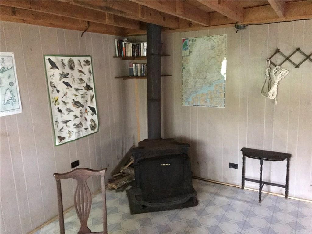 Xx Mt Tom Road Pembroke, ME 04666 - Photo 14 of 34 Woodstove in the corner of the camp.