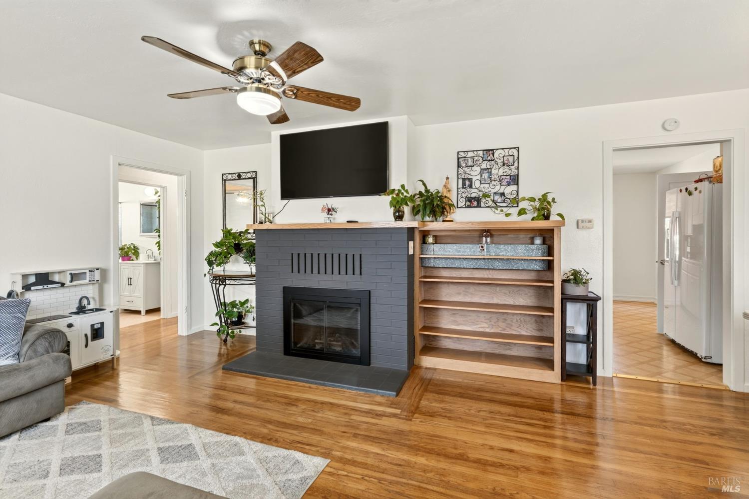 92 Oak Knoll Road Ukiah, CA 95482 - Photo 6 of 35 a living room with furniture a fireplace and a flat screen tv