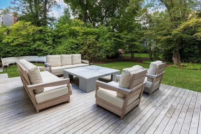 a view of a patio with couches chairs and a table with garden view