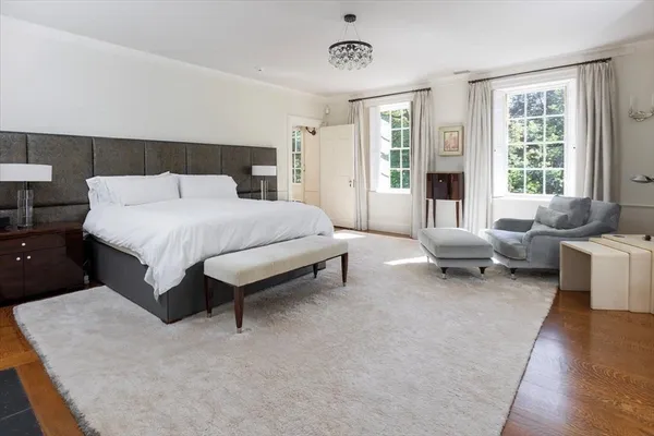 a spacious bedroom with a bed and glass window