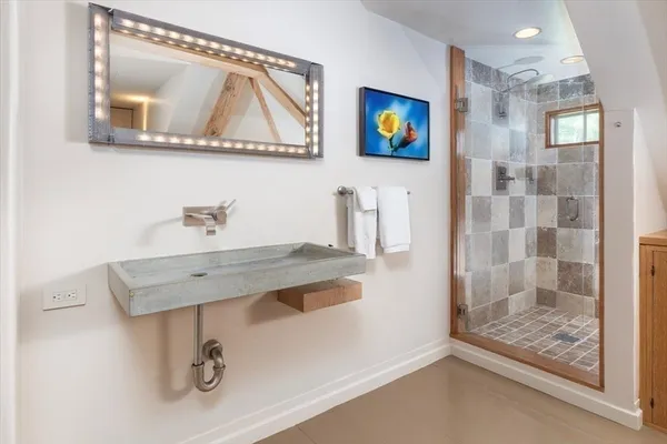 a bathroom with a sink a mirror and glass door