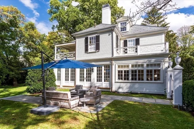 a view of a house with backyard and sitting area