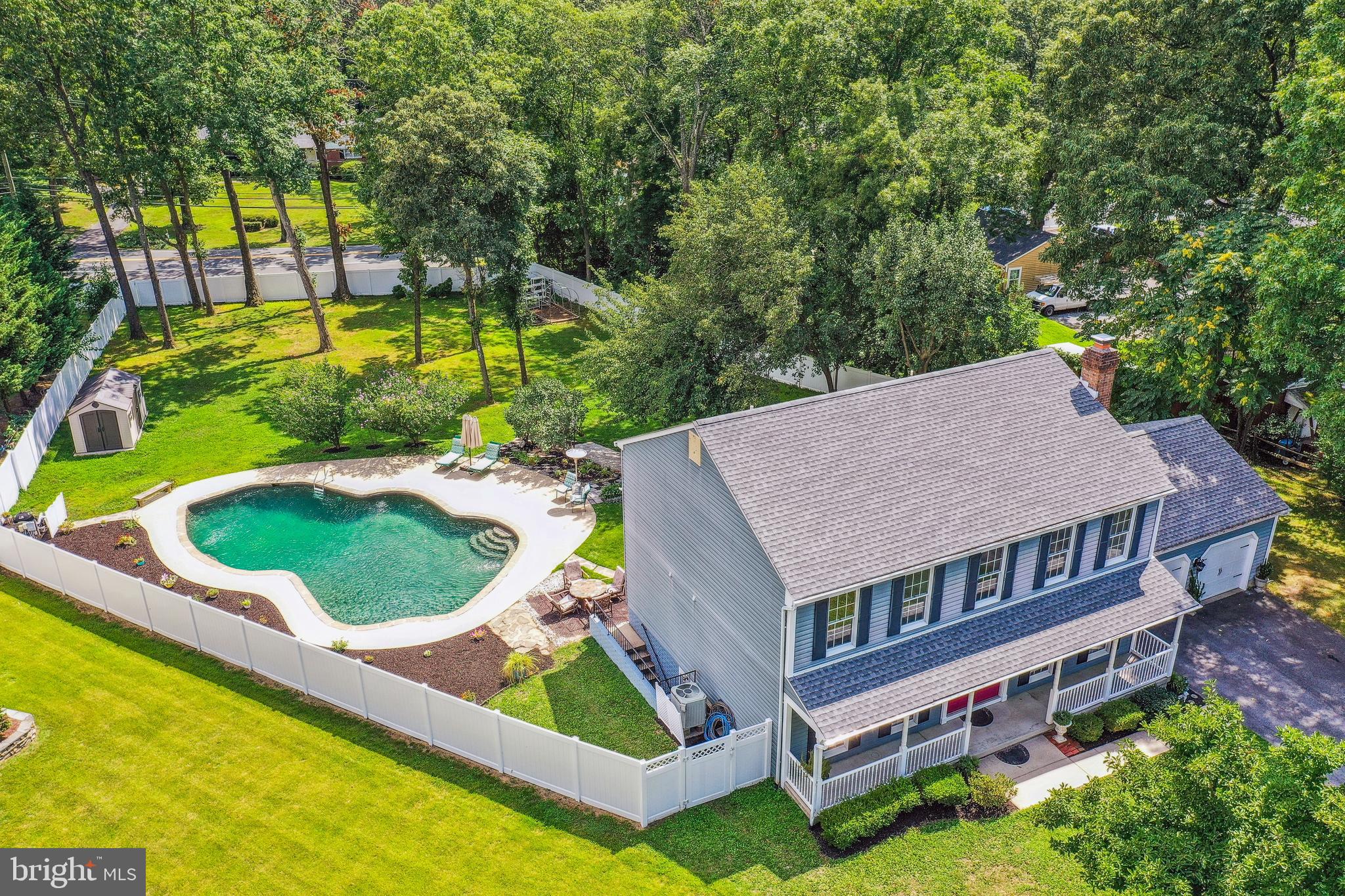 735 Evergreen Road Severn, MD 21144 - Photo 44 of 47 an aerial view of a house with swimming pool and large trees