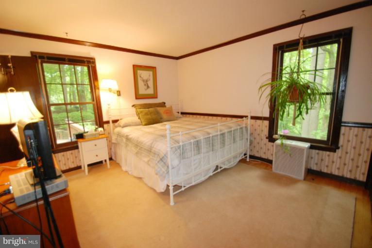 14123 Sunnybrook Road Phoenix, MD 21131 - Photo 13 of 30 a bedroom with a bed and a night stand