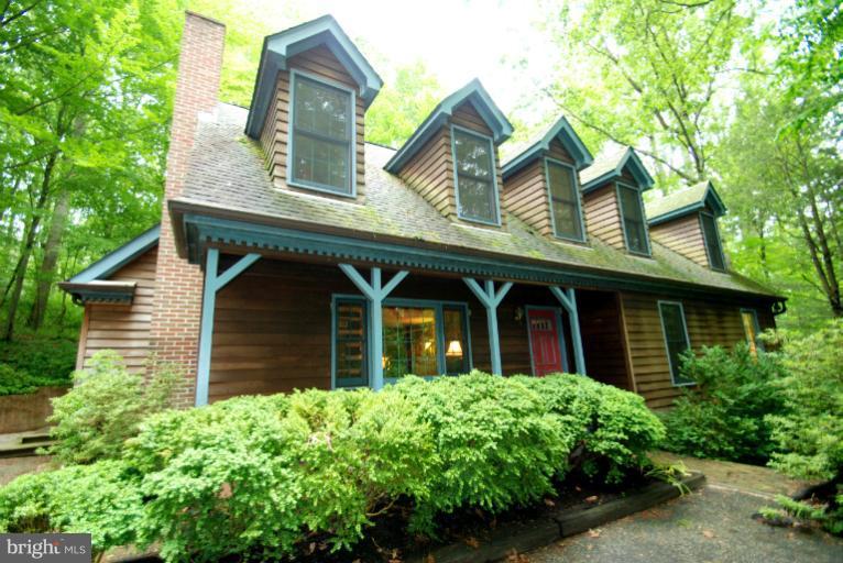 14123 Sunnybrook Road Phoenix, MD 21131 - Photo 25 of 30 a view of brick house with a large windows and flower plants