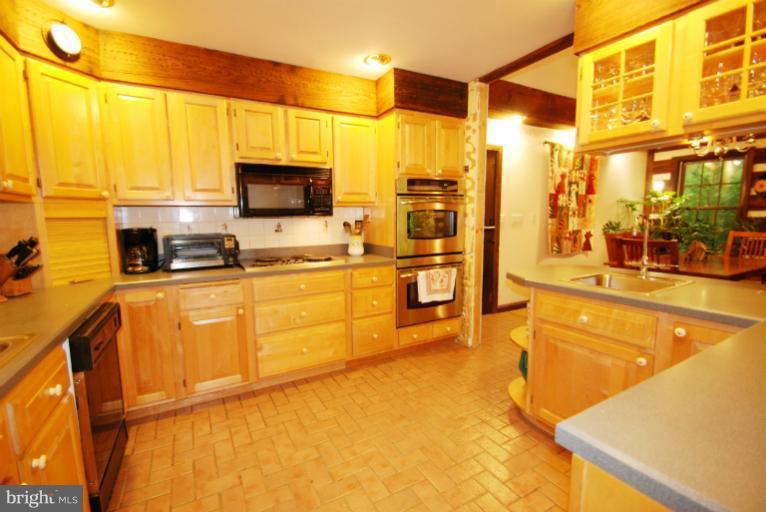 14123 Sunnybrook Road Phoenix, MD 21131 - Photo 6 of 30 a kitchen with stainless steel appliances granite countertop a sink and cabinets