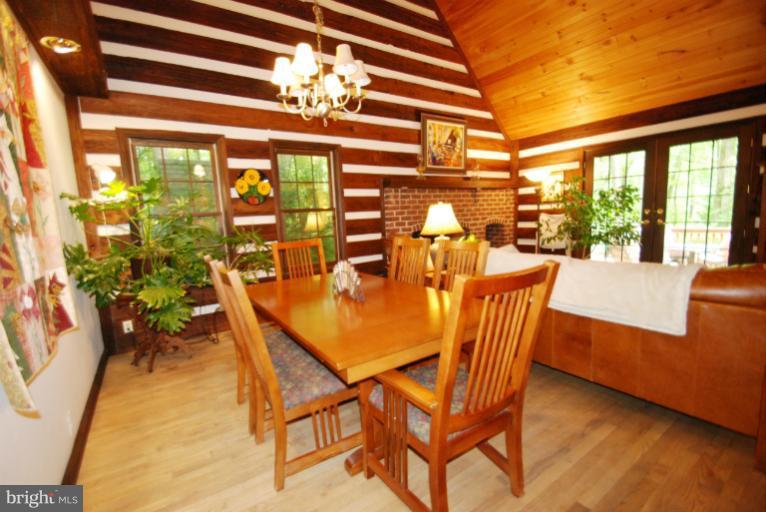 14123 Sunnybrook Road Phoenix, MD 21131 - Photo 8 of 30 a dining room with furniture a chandelier and wooden floor