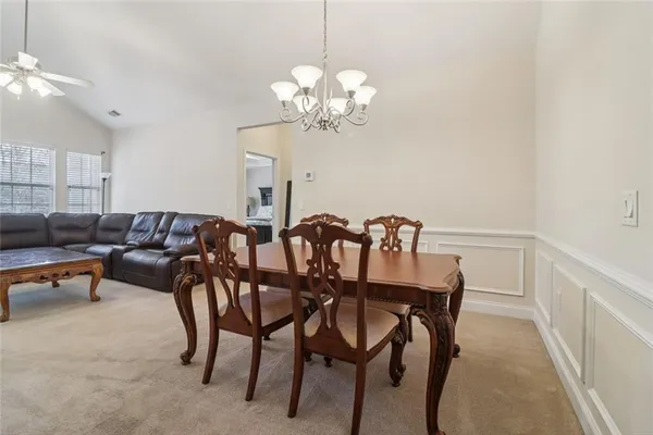 a view of a livingroom with furniture wooden floor windows and a fireplace