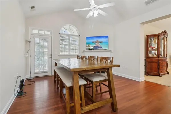 a dining room with kitchen island furniture a chandelier and kitchen view