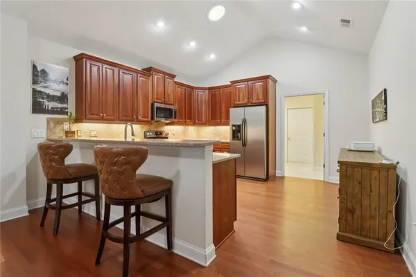 a kitchen with a table chairs and a refrigerator