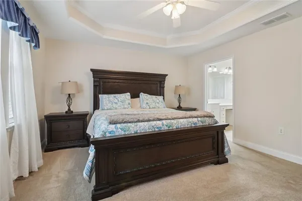 a bedroom with a large bed and a flat screen tv