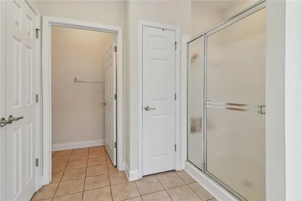 a bathroom with a double vanity sink mirror and a shower
