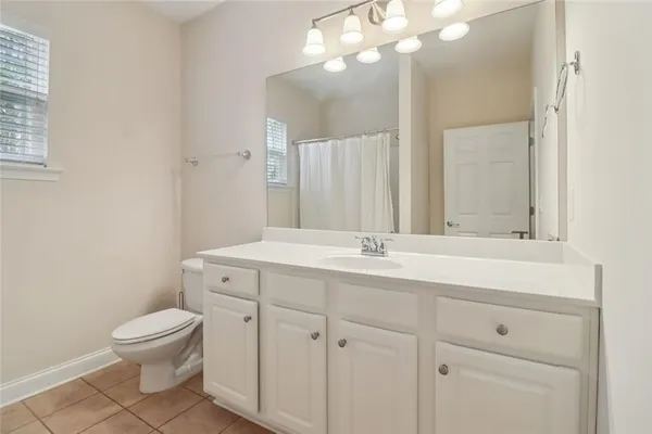 a bathroom with a shower a toilet and a sink