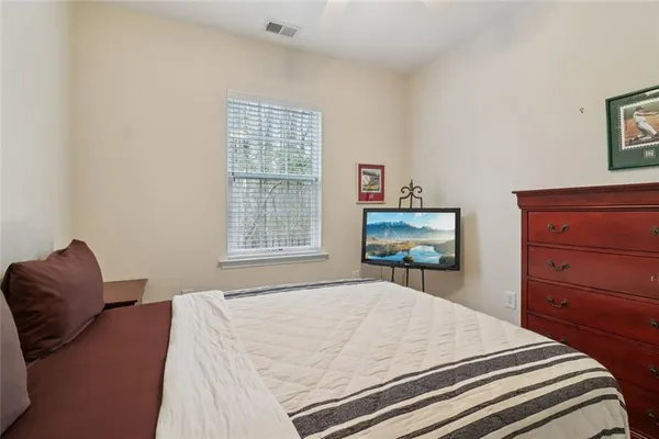 a bedroom with a bed and a dresser