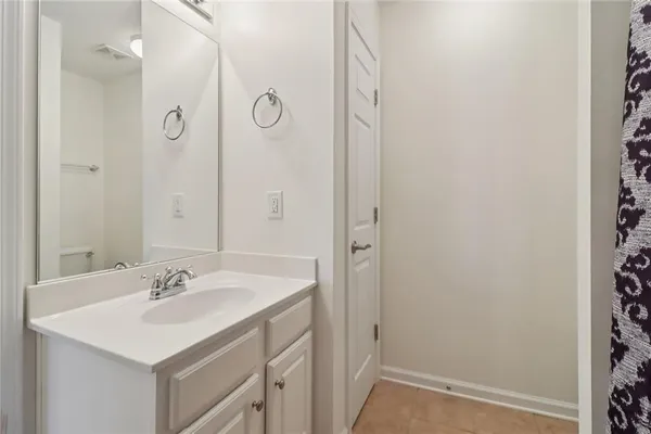 a view of a porch with a bench and floor to ceiling window