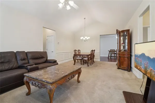 a view of a dining room with furniture and chandelier