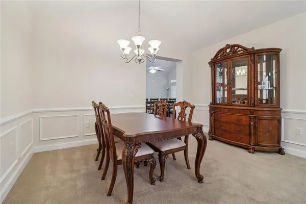 a view of a dining room with furniture wooden floor and a chandelier