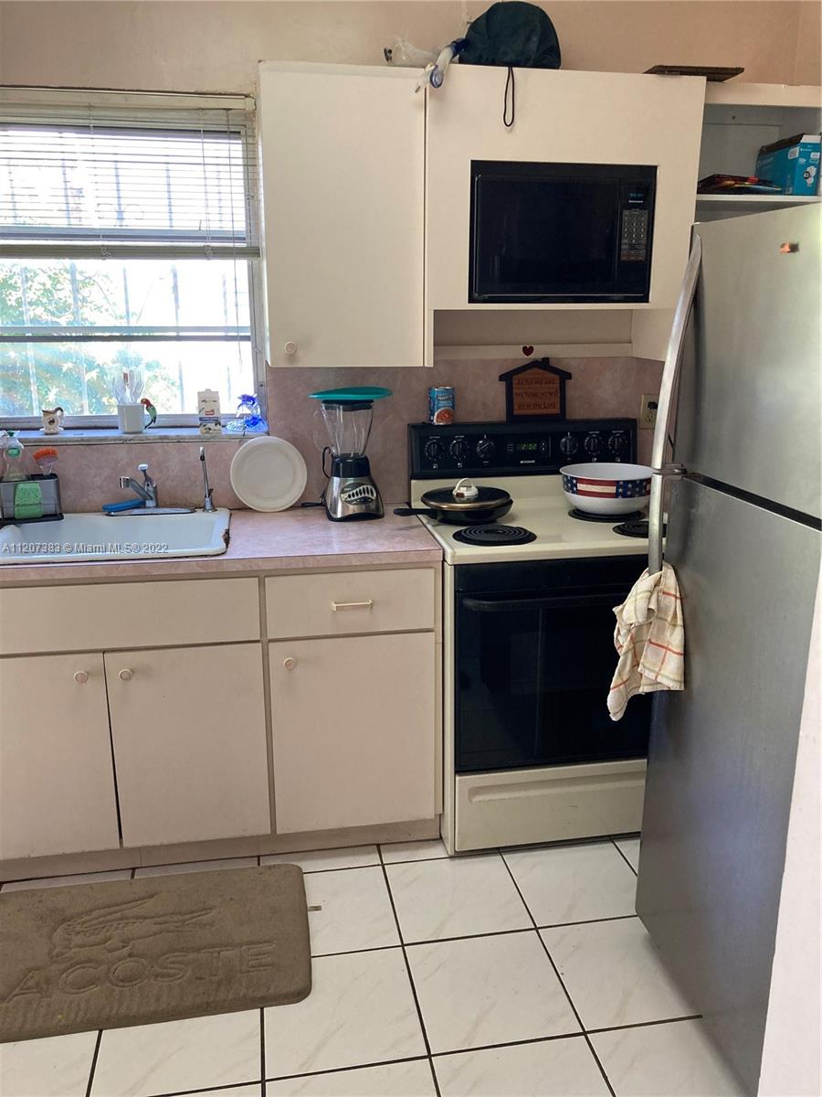 1254 Southwest 13th Avenue Miami, FL 33135 - Photo 5 of 7 a kitchen with stainless steel appliances a stove a refrigerator and a sink