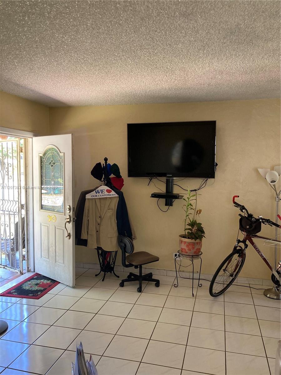 1254 Southwest 13th Avenue Miami, FL 33135 - Photo 6 of 7 a view of a livingroom with furniture and a flat screen tv