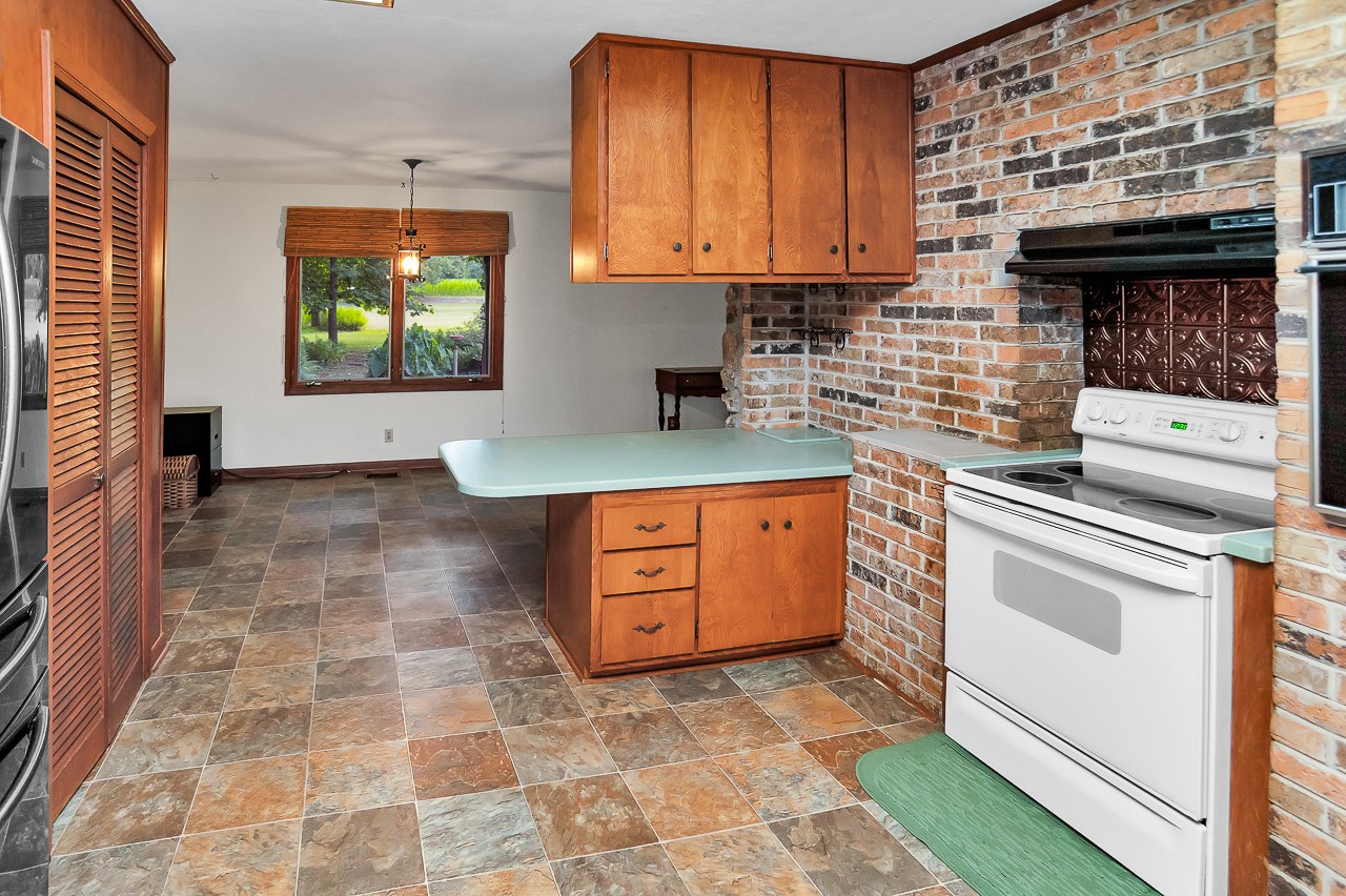 253 Hunter Road Fayetteville, TN 37334 - Photo 20 of 61 a kitchen with stainless steel appliances granite countertop a stove a sink and a microwave