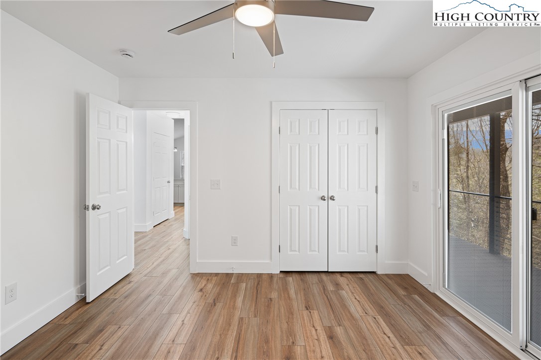 114 Woodpecker Road Purlear, NC 28665 - Photo 18 of 47 a view of an empty room with wooden floor and a window