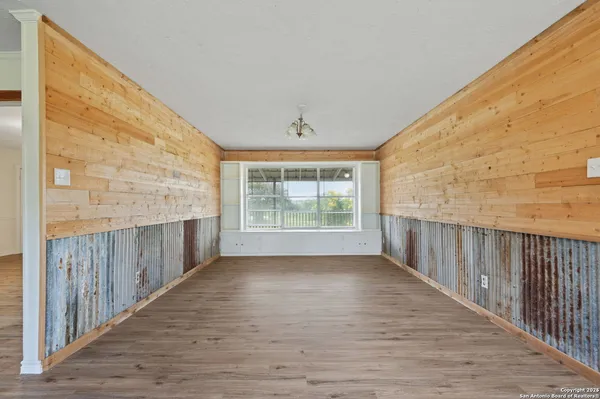a view of a porch with wooden floor and fence