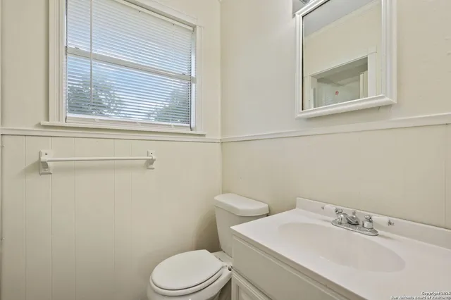 a white toilet sitting next to a bathroom sink