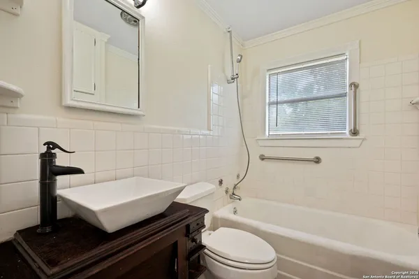 a bathroom with a sink a toilet and bathtub