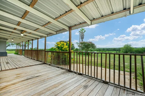a view of balcony with wooden floor