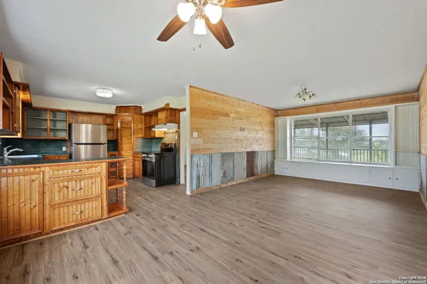 a view of a kitchen with furniture and a ceiling fan