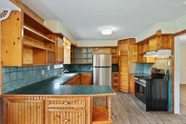 a kitchen with stainless steel appliances kitchen island granite countertop a refrigerator and a stove