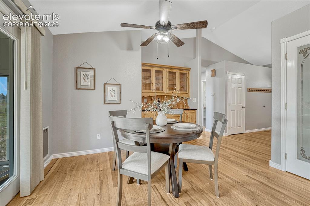 13695 Woodlake Road Elbert, CO 80106 - Photo 14 of 39 Dining area with oak floors and built-in hutch.