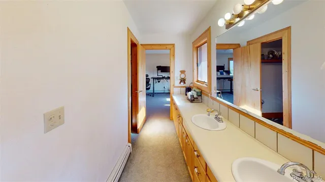 a bathroom with a sink mirror and vanity