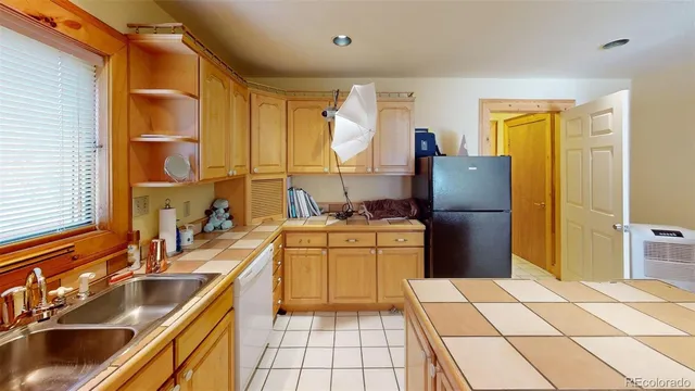 a kitchen with stainless steel appliances granite countertop a sink a counter space and cabinets