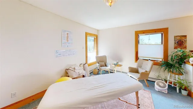 a bedroom with a bed and a potted plant