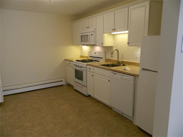 59 Prospect Street, Unit A4 Marblehead, MA 01945 - Photo 2 of 6 a kitchen with a stove and a sink