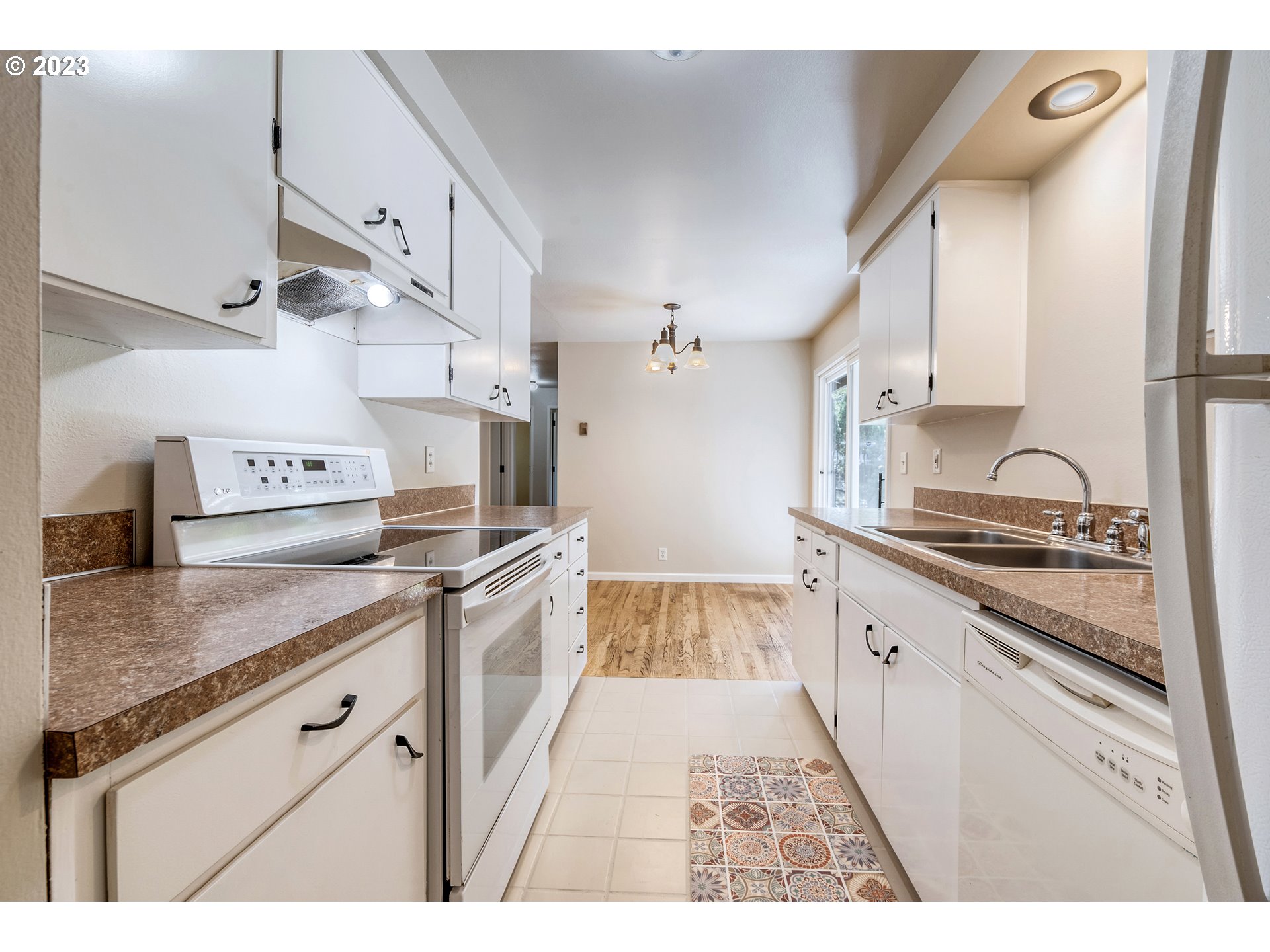 4439 Camellia Street Springfield, OR 97478 - Photo 12 of 31 a kitchen with stainless steel appliances granite countertop a sink stove and refrigerator