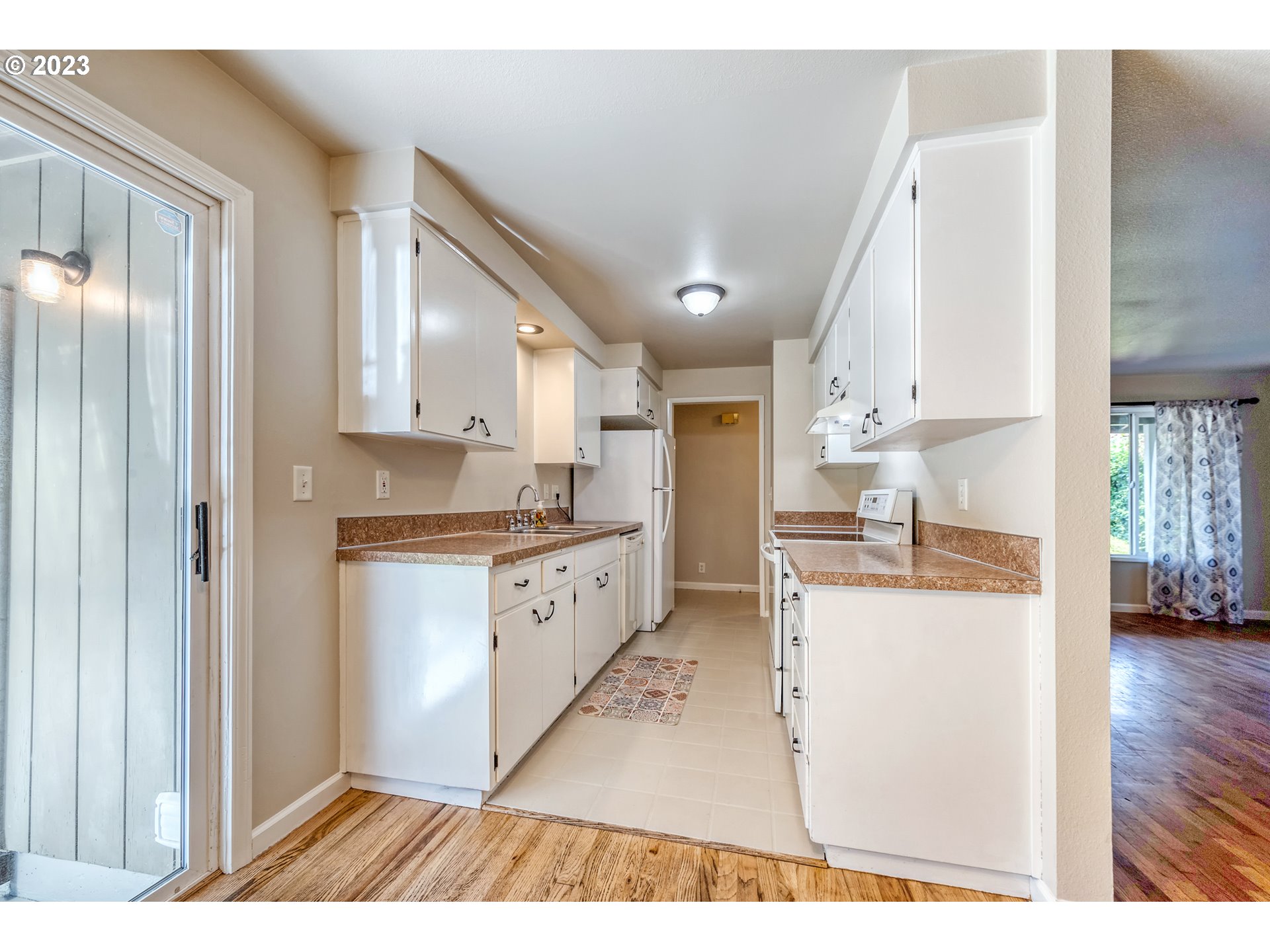 4439 Camellia Street Springfield, OR 97478 - Photo 13 of 31 a open kitchen with cabinets and wooden floor