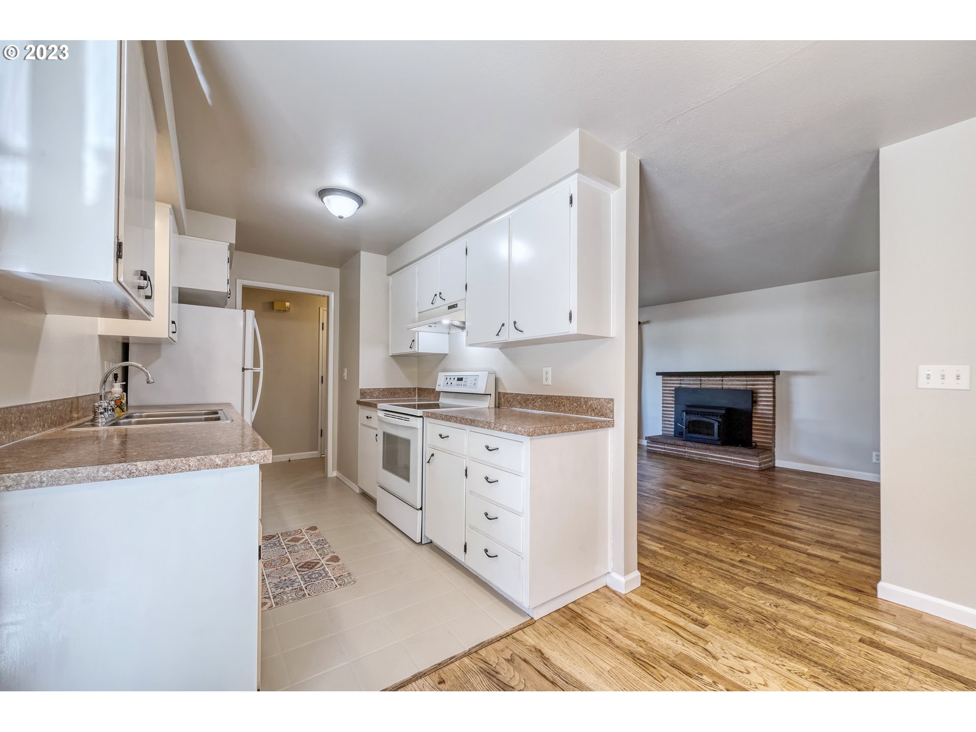 4439 Camellia Street Springfield, OR 97478 - Photo 15 of 31 a kitchen with granite countertop a sink cabinets and stainless steel appliances