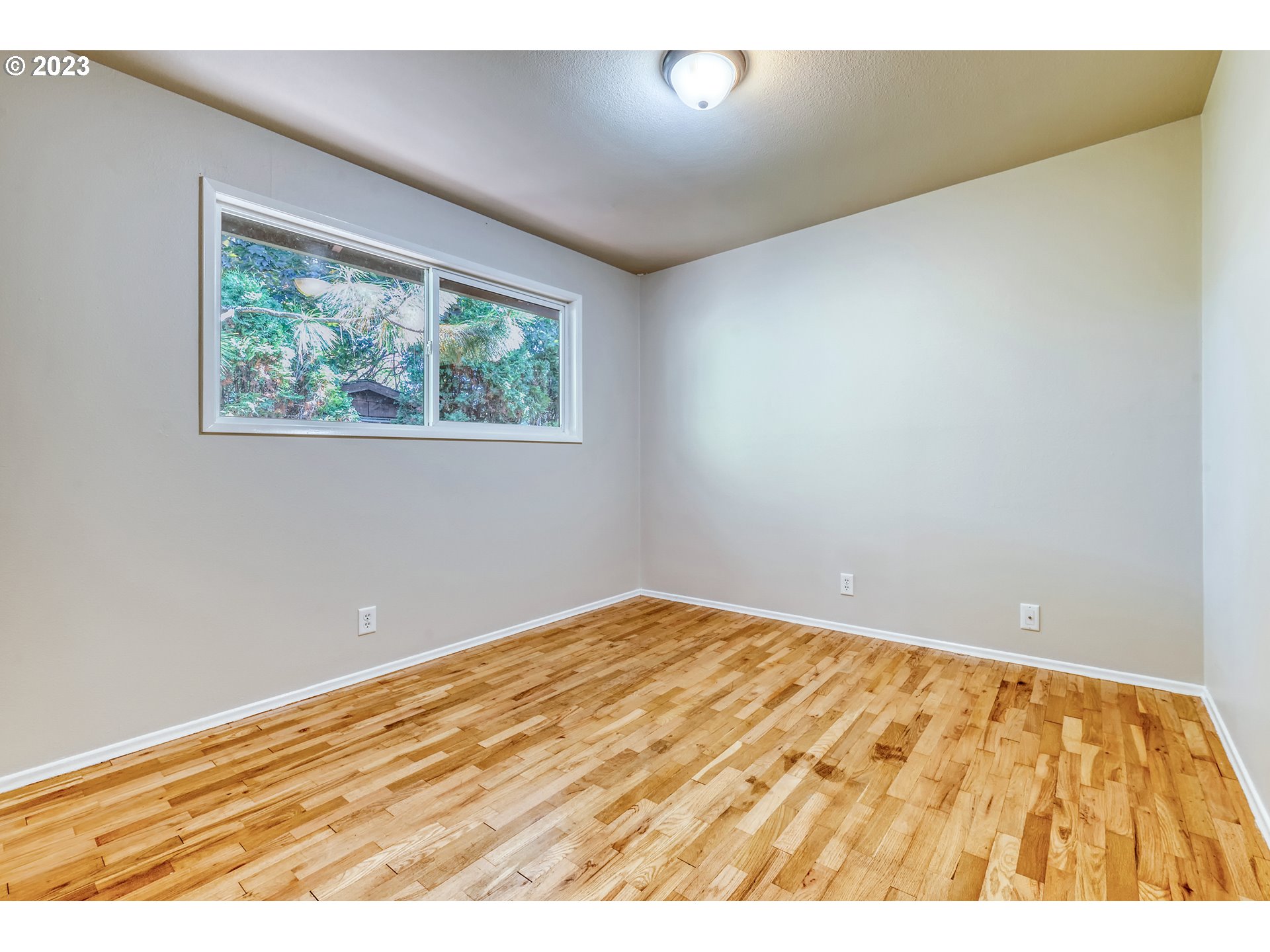 4439 Camellia Street Springfield, OR 97478 - Photo 23 of 31 an empty room with wooden floor and windows