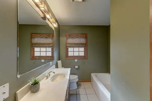 a bathroom with a sink a toilet a tub and shower