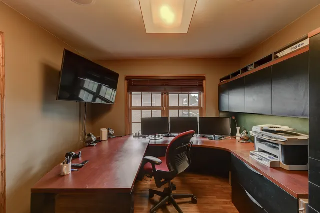 a view of a workspace with furniture and a window