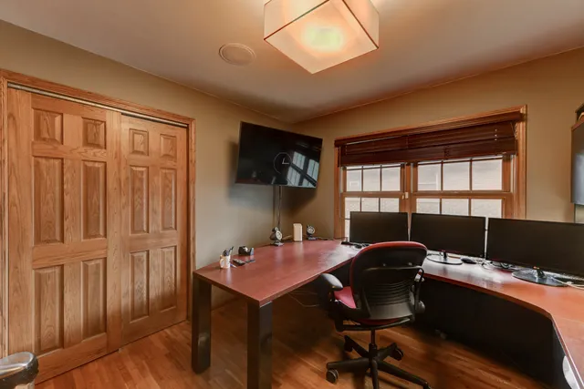 a view of a workspace with furniture and a window