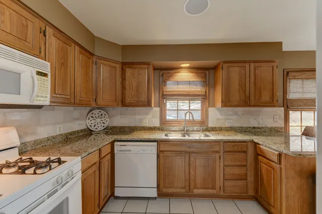 a kitchen with stainless steel appliances granite countertop a sink stove and cabinets