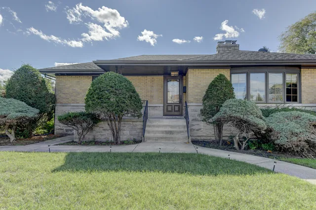 a view of a house with a yard and a garden